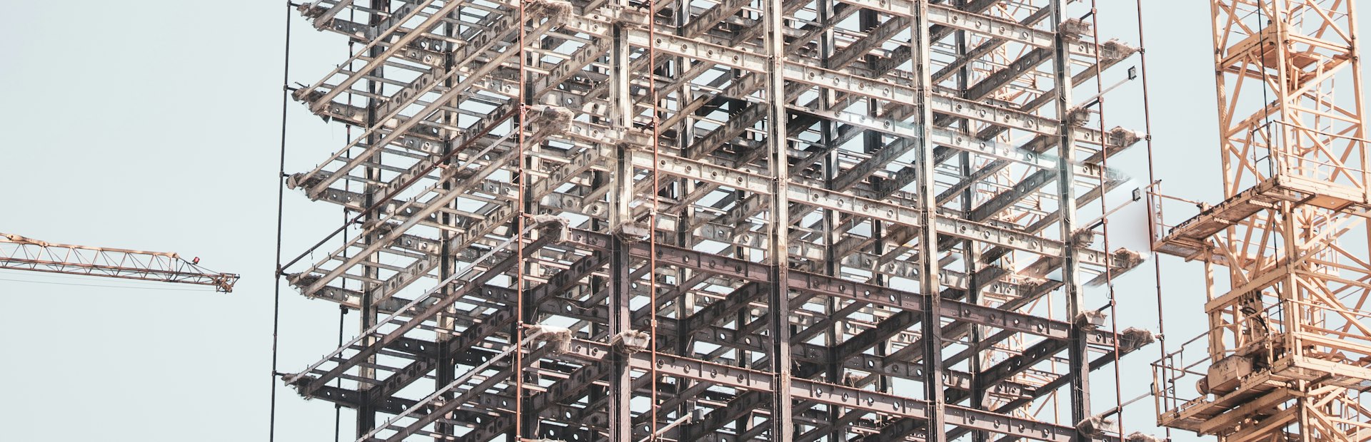 Structural steel frame and tower cranes on a construction site